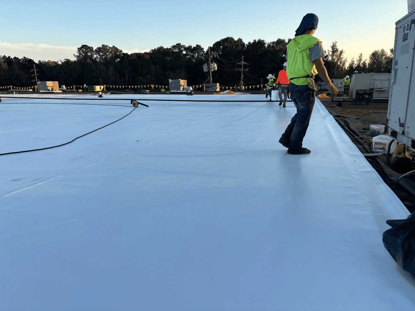 TPO installation crew at golden hour